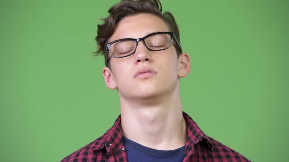 Young Handsome Teenage Nerd Boy Relaxing with Eyes Closed alt