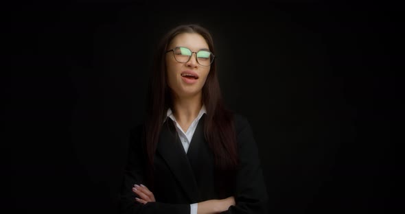 Business Woman with Glasses Winks with One Eye at the Camera
