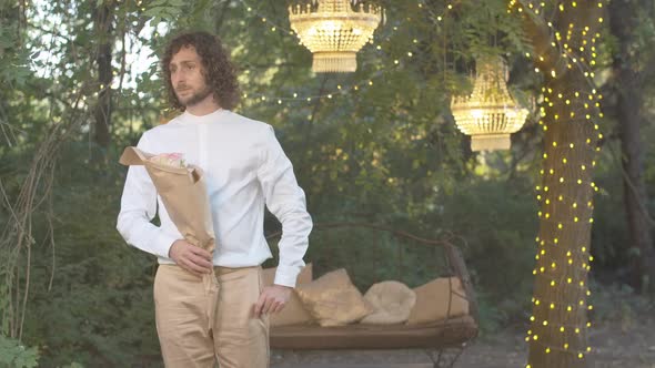 Romantic Man Waiting for Girlfriend in the Evening. Portrait of Nervous Caucasian Young Curly-haired alt