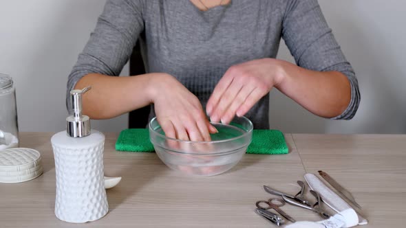 Woman Prepares a Solution Hand Bath alt