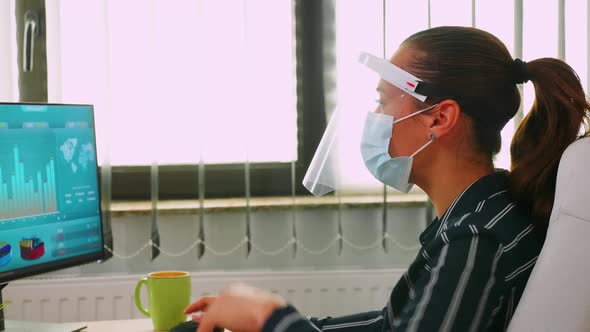 Close Up of Businesswoman Wearing Protection Mask on Desk Office alt