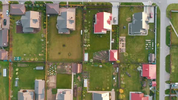 Cottage Houses with Colorful Roofs Surrounded By Green Lawns alt