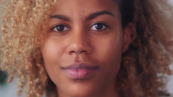 Closeup Camera View of Young Blonde African American Woman Looking at Camera alt