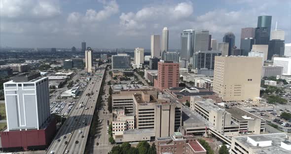 This video is an aerial of downtown Houston skyscrapers and surrounding area on a sunny day. This vi alt