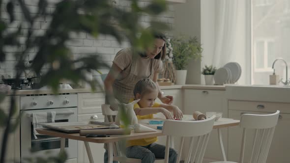 Mom and Child Cook in the Kitchen