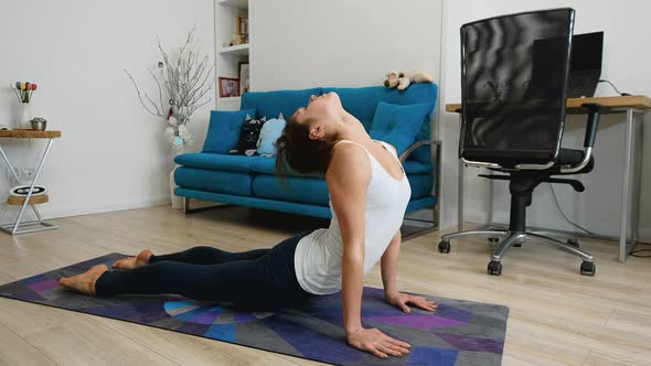 Young Woman Practicing Yoga At Home