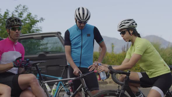 Group of cyclists taking break and preparing for ride.  Fully released for commercial use.