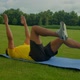 Sporty Fit African American Man Practicing Dead Bug Exercise in Public Park - VideoHive Item for Sale
