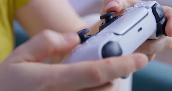 Person Holds a Controller for Game Console in Hands and Intensively and Nervously Presses Buttons