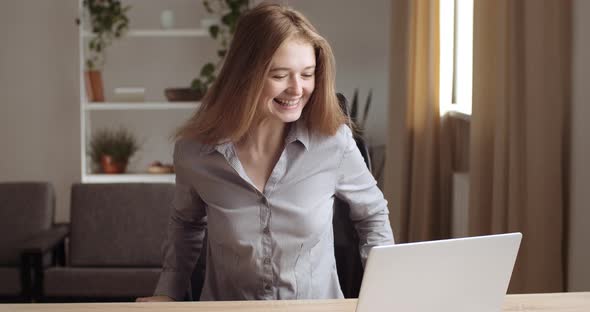 Portrait of Teenage Girl Looks at Laptop Screen, Reads Good News, Gets Positive High Mark on Exam alt