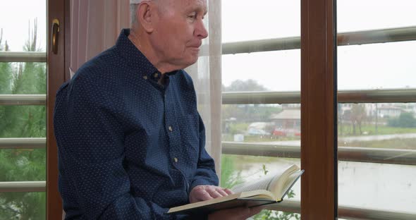 An Old Muslim Man Reading Koran