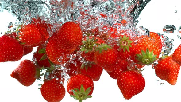 Super Slow Motion Shot of Falling Strawberries Into Water at 1000Fps alt
