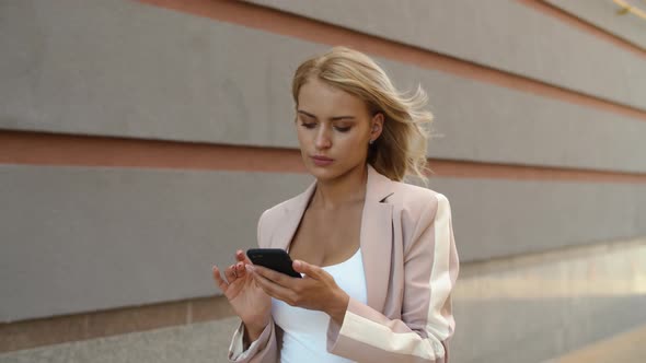 Closeup Businesswoman Using Phone at Street. Woman Messaging on Phone at Street alt