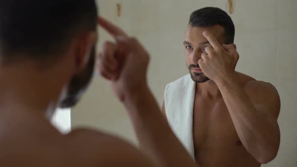 Metrosexual Applying Moisturizing Lotion and Massaging Face, Body Care Cosmetics alt