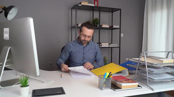 Angry at the document in his hand, the man throws it away. alt