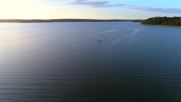 Drone Shot Flying Over Lake and Small Boat