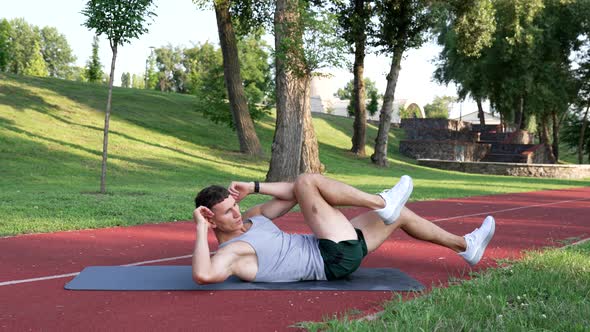 Athletic Guy Trainer Strengthening My Core with Bicycle Exercise Outdoor Energizer alt