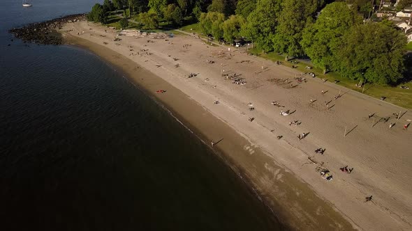 People Sunbathing And Enjoying The Reopened Kitsilano Beach With Downtown Skyline And English Bay Be alt