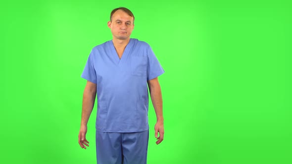 Upset Man Disappointed Looks at Camera and Shrugs. Green Screen alt