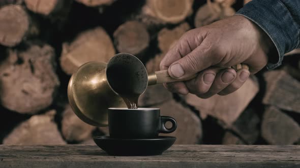 Tradition oriental coffee. Coffee is poured into a black mug made of copper cezve alt