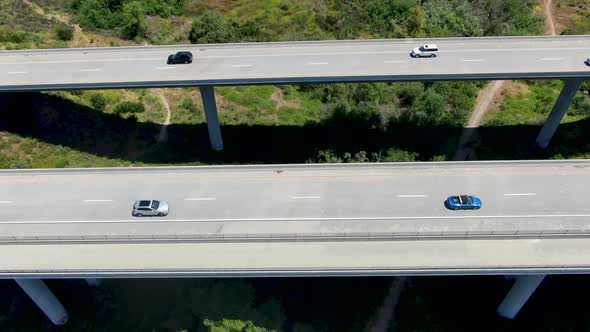 Aerial View of Road Highway Bridge, Viaduct Supports in the Valley Among the Green Hills. alt