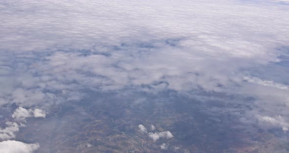 The View From the Plane of Fluffy Clouds in Desert Mountains From an Airplane New Mexico USA alt