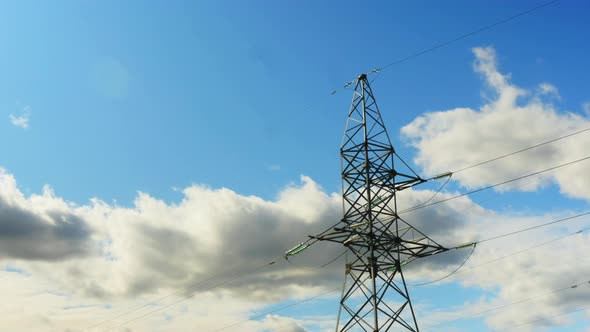 4k Electric Transmission Line On A Background Of Blue Sky With Clouds alt