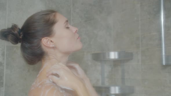 Pretty Lady Washing in Shower with Soap Foam Cleaning Skin Enjoying Body Care alt