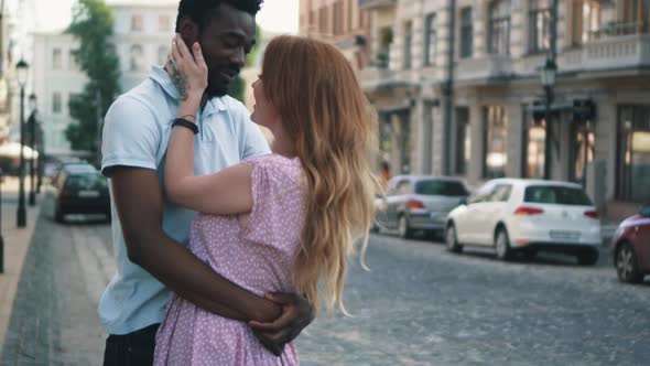 Young Couple in Love Standing and Tenderly Cuddling on Streets of European Cities alt