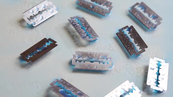 Razor Blades With Water Droplets. Rotation