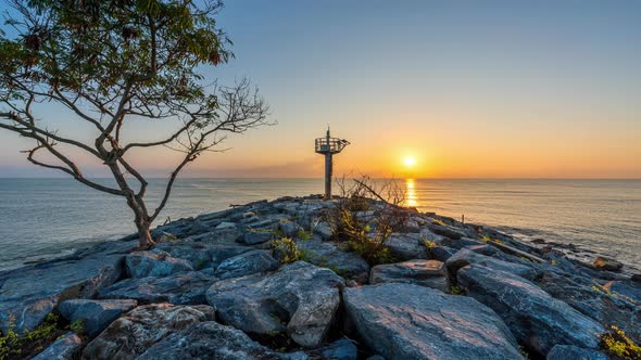 4K Motion timelapse of sunrise at lighthouse, Nakhon Si Thammarat, Thailand alt