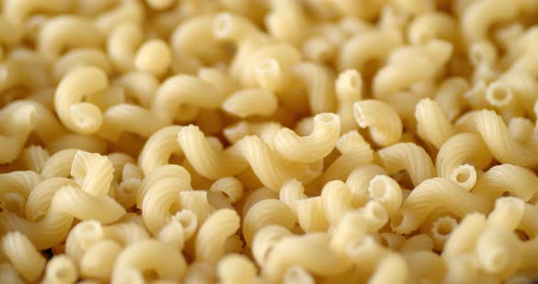 Cavatappi Pasta Dry Rotates Slowly on the Table alt