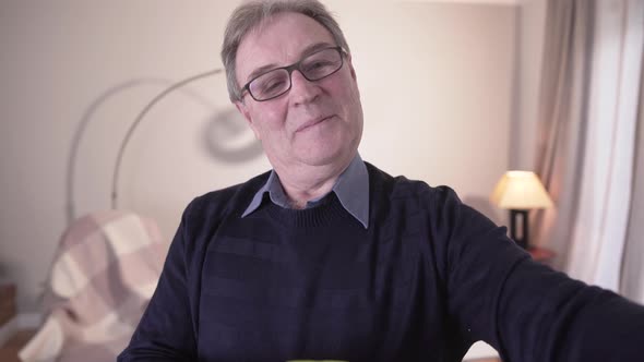Front View of Elegant Senior Caucasian Man Sticking Note on Mirror and Repeating Word Written alt
