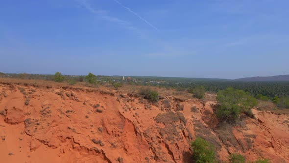 Aerial Slowmotion Shot of a Red Canyon or Fairy Stream at the Border of Desert in the Mui Ne Village alt