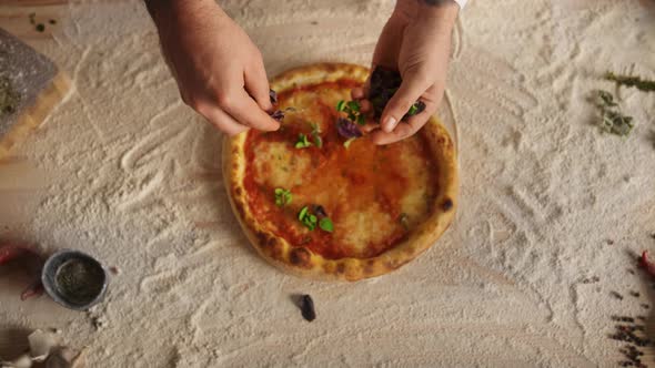 Chef Hands Preparing Recipe Adding Ingredients on Italian Pizza at Restaurant alt