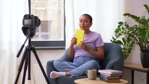 Female Video Blogger Making Review of Book alt