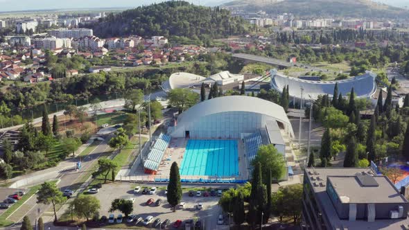 Drone Flying Over an Outdoor Pool That Stands in the City Center alt