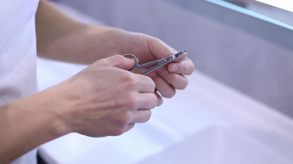 Close Up Man Doing Manicure and on Bath Cutting Nails alt