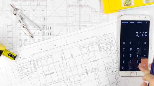 Engineers Fix Errors on Drawings, and Discuss Cooperation. Close Up alt