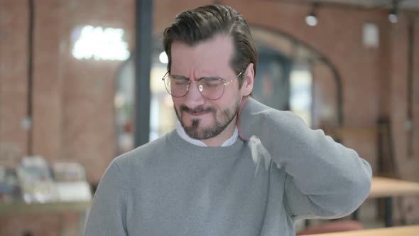 Portrait of Young Man Having Neck Pain alt