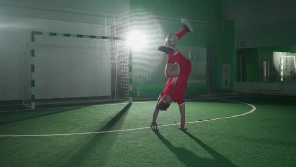 Slow Motion Professional Football Player Performs Series of Tricks with a Soccer Ball Balances the alt