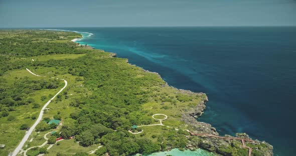 Aerial View of Turquoise Salt Water Lake at Green Tropic Trees alt