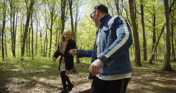 Dad And Daughter In Summer, Happy Child Jumps Tattoo On His Hands alt