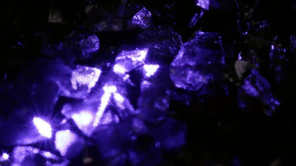 Purple glow shining off small rocks spinning alt