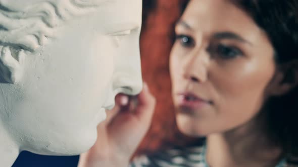 White Gypsum Bust is Getting Brushed By a Lady alt