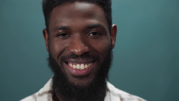 An Attractive Black Guy Smiles at the Camera and Swings in Different Directions alt