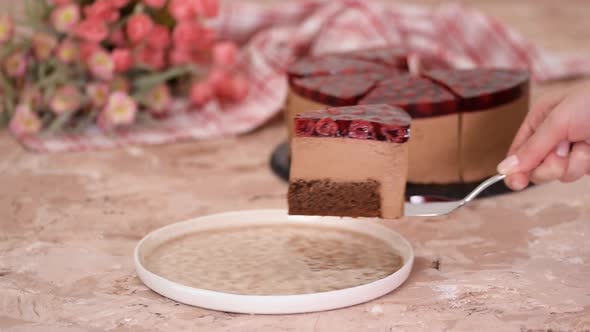 Piece of Delicious Chocolate Mousse Cake with Cherry Jelly on Top