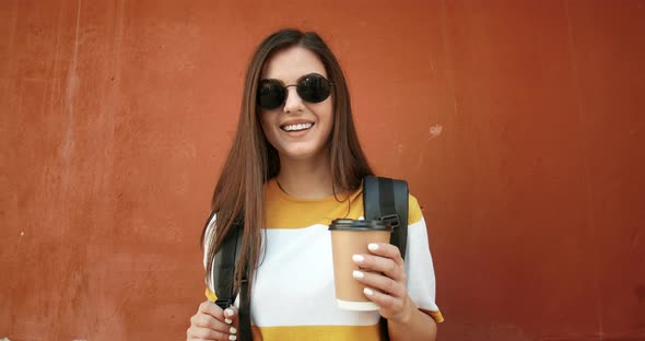 Portrait of Girl with Coffee Near Wall