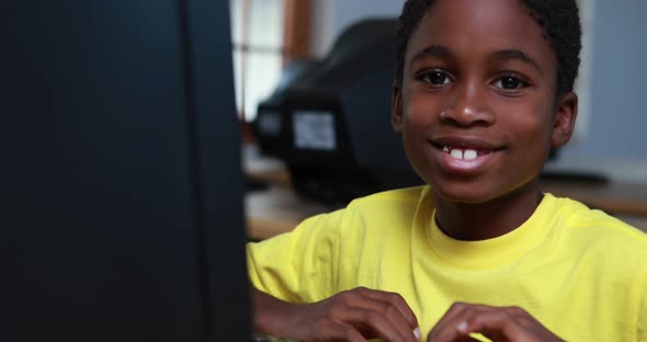 Little Boy Smiling at Camera during Computer Class alt