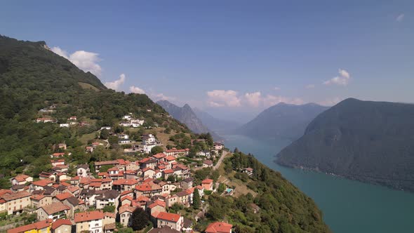 Beautiful aerial over mountain Brè and lake Lugano on a bright sunny summer day alt